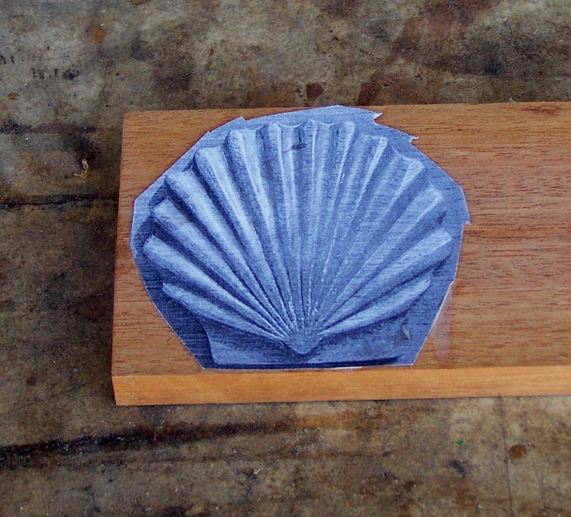 The template glued to the wood